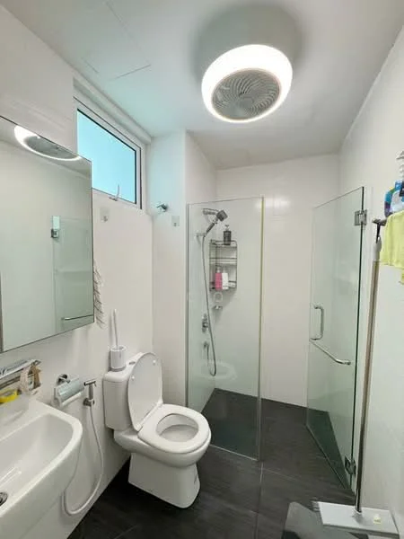 Bathroom features: white tiled walls, black tiled flooring, walk-in shower with glass enclosure, rain shower head, handheld shower, single-sink vanity with mirror, one-piece toilet, recessed ceiling light, exhaust fan, shower shelf, window for natural light; style: modern.