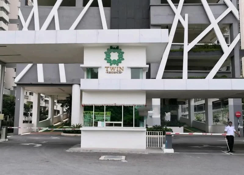 Exterior type: high-rise condominium; features: modern facade with geometric design, white painted facade, guard house at entrance, boom gate, landscaped greenery, driveway with interlocking pavers; style: modern.