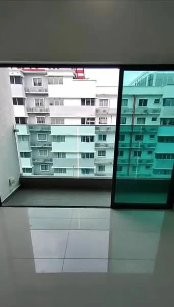 Room features: sliding glass door, floor-to-ceiling windows, white painted walls, glossy tile flooring, balcony view of adjacent building; view: city.