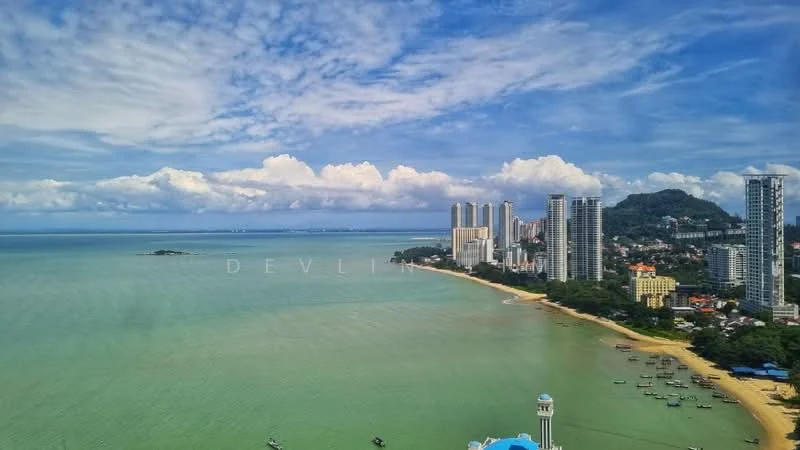 Exterior type: high-rise condominium; features: city skyline, sea view, beachfront, tall residential buildings, clear blue sky, greenish water, coastal landscape; style: modern.