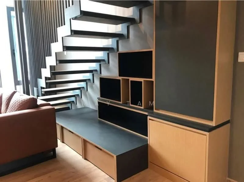 Living features: open shelving unit, black and wood cabinetry, TV console, staircase with wooden treads, wooden flooring, large windows, sofa in beige, decorative wall paneling; style: modern.