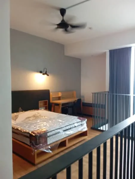 Bedroom features: queen-size bed with mattress, wooden bed frame, wooden desk, wooden chair, black ceiling fan, grey painted walls, large window with curtains, wooden flooring, wall-mounted light fixture, balcony railing; style: modern.