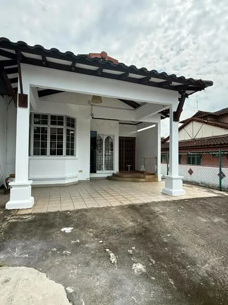 Exterior type: detached bungalow; features: white painted facade, pitched tile roof, front porch with tiled flooring, large windows with grid pattern, wooden door, fenced perimeter, concrete driveway, surrounding residential area; style: traditional.