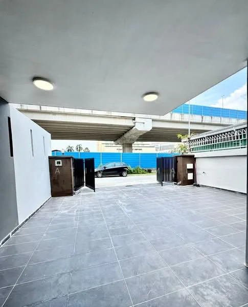 Exterior features: grey tiled flooring, white painted walls, overhead lighting fixtures, open space, fenced perimeter, visible road access, surrounding construction barriers; style: modern.
