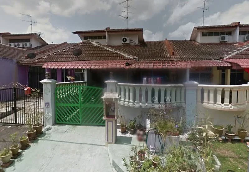 Exterior type: linked terrace house; features: green metal gate, brick facade, red tiled roof, front porch with railing, potted plants along walkway, two-storey structure, visible air conditioning units, satellite dishes on roof; style: traditional.