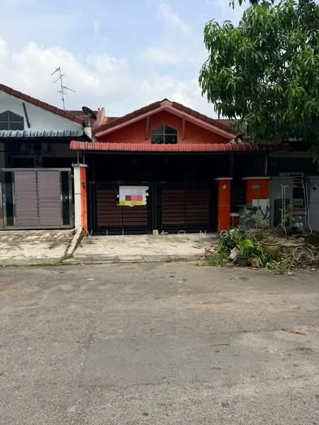 Exterior type: linked terrace house; features: red painted facade, metal gate, sliding doors, concrete driveway, manicured lawn, paved walkway, single-storey, gabled roof, overhanging eaves, visible utility poles, surrounded by greenery; style: modern.