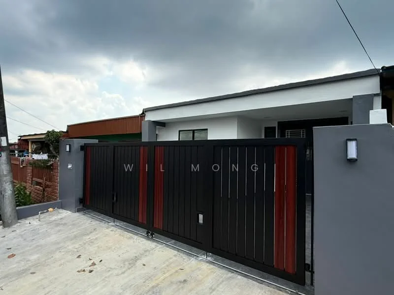 Exterior features: black metal gate with wooden accents, concrete driveway, grey painted facade, modern wall-mounted light fixtures, single-storey structure, surrounded by low fencing, asphalt road, cloudy sky; style: modern.
