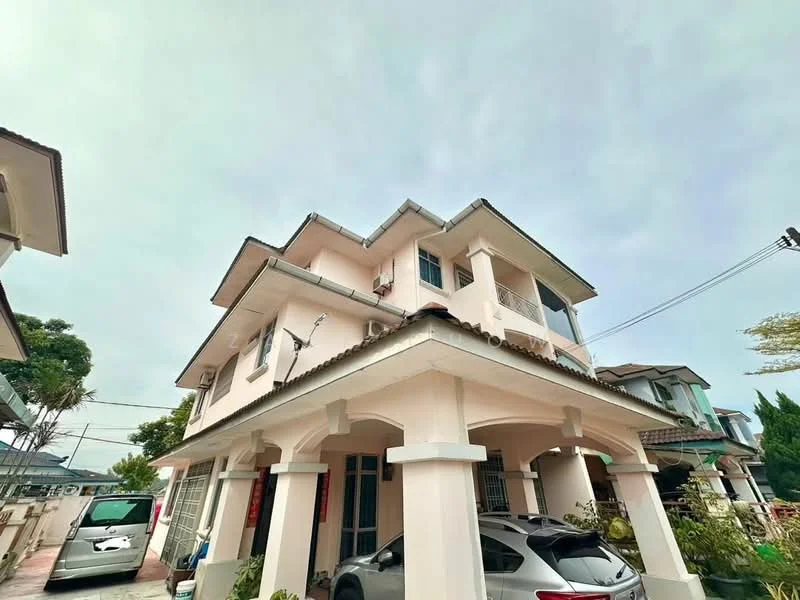 Exterior type: semi-detached house; features: light pink painted facade, flat roof, two-storey structure, covered car porch, driveway with interlocking pavers, balconies on upper floor, manicured landscaping, visible air conditioning units, surrounded by greenery; style: modern.