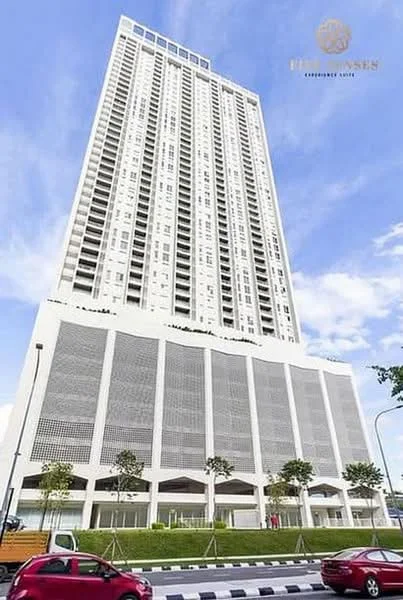 Exterior type: high-rise condominium; features: glass curtain wall, white painted facade, recessed balconies, vertical fins, manicured landscaping, trees along the walkway, multi-storey structure, modern architectural design; style: modern.