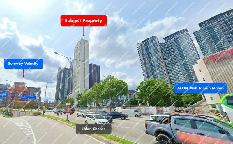 Exterior type: high-rise condominium; features: glass curtain wall, white painted facade, surrounded by mature greenery, adjacent to highway, urban context with commercial buildings, visible signage for AEON Mall Taman Maluri, multiple storeys, modern architectural design; style: modern.