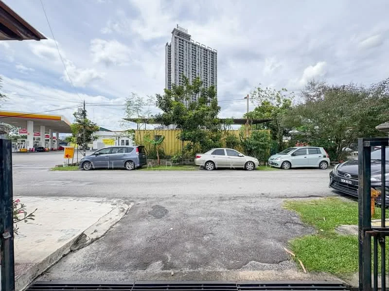 Exterior type: high-rise condominium; features: surrounded by mature greenery, manicured lawn, open-air parking lot, adjacent to highway, city skyline in background; style: modern.
