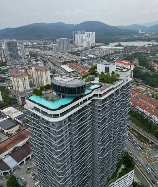 Exterior type: high-rise condominium; features: glass curtain wall facade, rooftop infinity pool, landscaped rooftop garden, recessed balconies, surrounded by urban skyline, approximately 20-storey high-rise, adjacent to main road, views of mountains in background; style: modern.