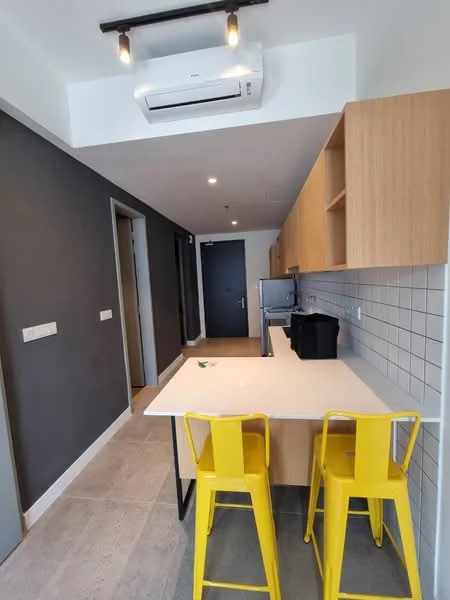 Kitchen features: light wood cabinetry, white countertop, grey accent wall, white tiled backsplash, stainless-steel fridge, built-in oven, 2 yellow bar stools, wall-mounted split AC, recessed lighting, open layout, floor tiles, kitchen island; style: modern.
