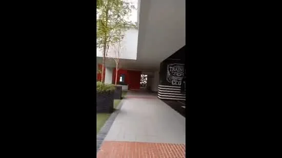 Exterior features: paved walkway, landscaped planters, modern architectural elements, overhang roof, red accent wall, decorative wall with signage; style: modern.