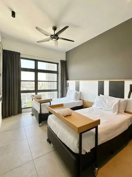 Bedroom features: two single beds with wooden side tables, white bedding, black bed frames, 5-blade ceiling fan, floor-to-ceiling windows, grey curtains, tile flooring, accent wall in dark grey, light wall with black and white panels; style: modern; view: city.