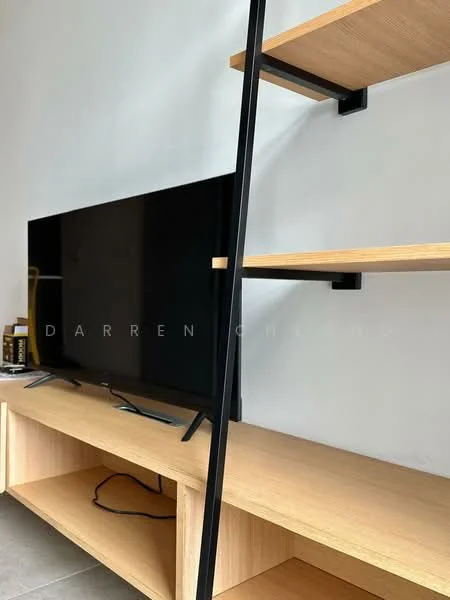 Living features: black flat-screen TV, light wood TV console, open shelving unit, grey tile flooring, minimalist design, wall-mounted shelving, cable management visible, neutral wall color; style: modern.