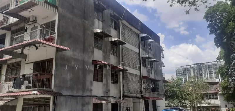Exterior type: low-rise apartment block; features: grey concrete facade, recessed balconies, metal railings on balconies, sliding windows, flat roof, approximately 3-storey, surrounded by mature greenery, adjacent to urban area; style: minimalist.