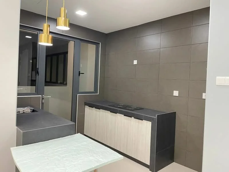 Kitchen features: grey tiled walls, light grey cabinetry, black countertop, built-in stove with two burners, pendant lighting with gold finish, window with black frame, light-colored flooring, open layout, kitchen island, electrical outlets on wall; style: modern.