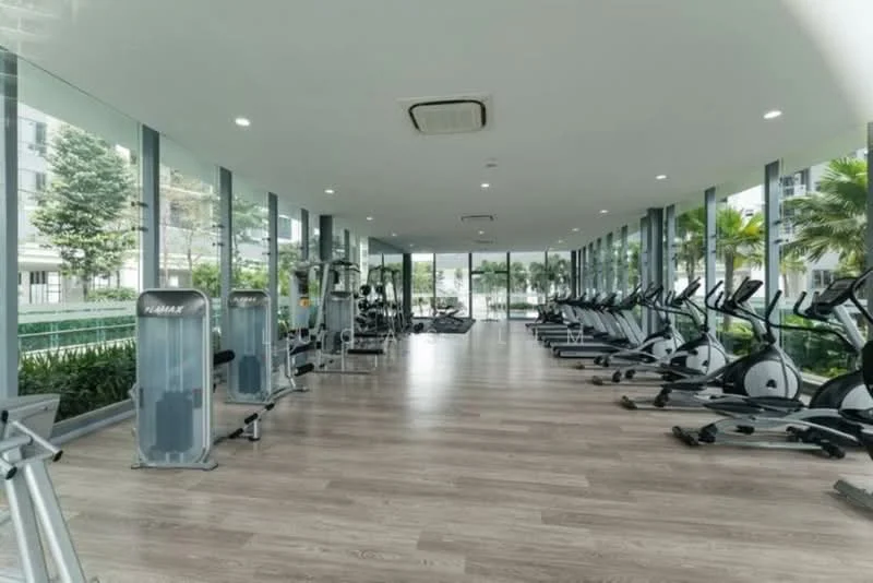Room features: large glass windows, wooden flooring, elliptical machines, stationary bikes, strength training equipment, mirrored wall, ceiling lights, greenery visible outside; style: modern; view: garden.