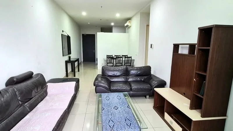 Living features: brown leather 3-seater sofa, brown leather 2-seater sofa, glass coffee table, wall-mounted TV, white painted walls, tile flooring, air conditioning unit, decorative wall shelf, dining area visible in background; style: modern.