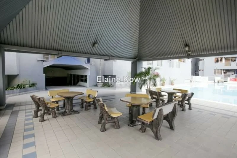 Exterior type: clubhouse; features: covered outdoor seating area, round dining tables, stool seating, tiled flooring, potted plants, swimming pool visible in background, grey painted walls, metal roof, open layout; style: modern.