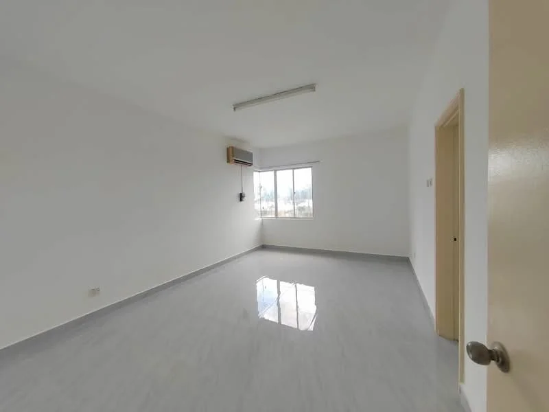 Room features: white painted walls, grey tile flooring, 1 wall-mounted split AC, large window with view, ceiling light fixture, door leading to another room, neutral decor; style: modern; view: garden.