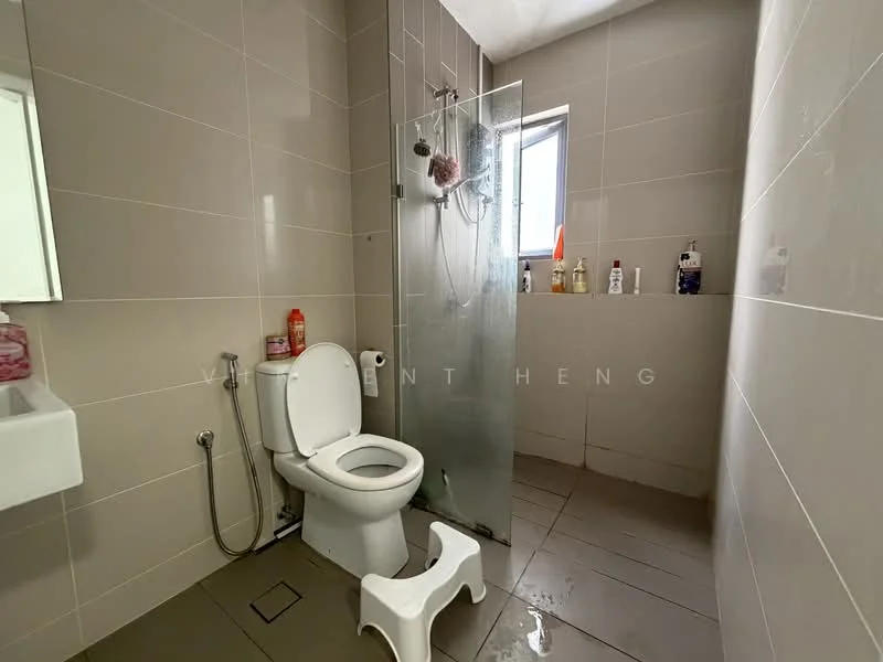 Bathroom features: white toilet, glass shower enclosure, chrome shower head, wall-mounted faucet, sink with cabinet, grey tiled walls, grey tiled flooring, window for natural light, toilet paper holder, soap dispenser, bottle storage, foot stool; style: modern.