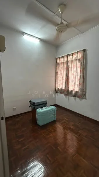 Room features: wooden flooring, white painted walls, ceiling fan, curtains with floral pattern, single window, small table, luggage, light source from window.