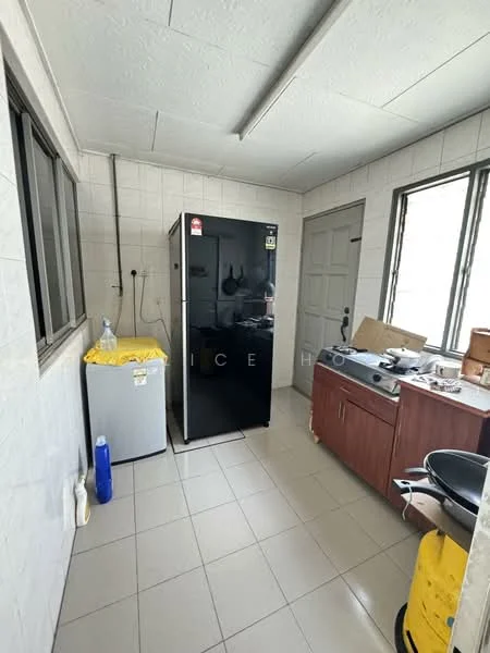 Kitchen features: black fridge, grey countertop, wood cabinetry, stainless-steel gas stove, single-basin sink, tile flooring, white tiled walls, window with grid pattern, door leading outside, kitchen utensils on countertop.