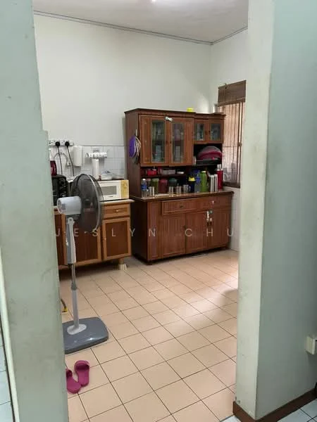Kitchen features: wood cabinetry, countertop with appliances, built-in microwave, freestanding refrigerator, kitchen sink, ceiling fan, tile flooring, window with curtains, open shelving, pink slippers on floor; style: traditional.