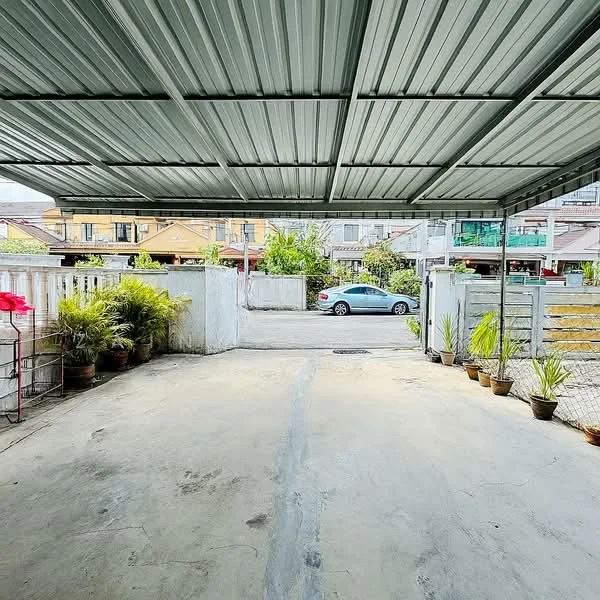 Exterior type: car porch; features: metal roof, concrete flooring, open-air parking, surrounded by low fencing, potted plants along the sides, driveway leading to the street; style: modern.