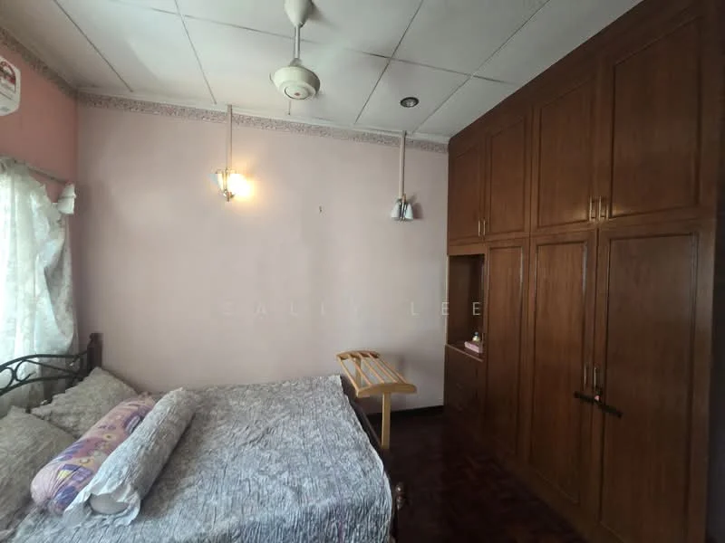 Bedroom features: queen-size bed with patterned bedding, wooden wardrobe with multiple doors, wooden drying rack, ceiling fan, wall-mounted light fixtures, pink painted walls, wooden flooring, curtains with sheer fabric; style: traditional.