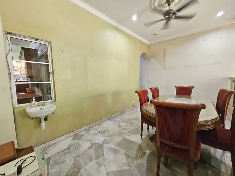 Dining features: round dining table, upholstered dining chairs in red, 5-blade ceiling fan, marble flooring, green painted walls, window with white frame, sink with faucet, arched doorway, decorative crown moulding; style: traditional.