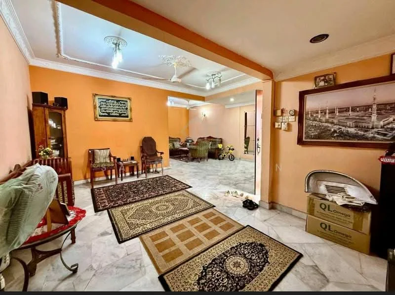 Living features: orange painted walls, marble flooring, tray ceiling with recessed lighting, 5-blade ceiling fan, two area rugs, wooden coffee table, wooden chairs, decorative wall art, sideboard cabinet, potted plants, shoe rack, boxes on the floor; style: traditional.