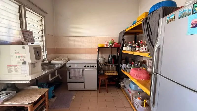 Kitchen features: white walls, tile backsplash, light brown tiled flooring, stainless-steel fridge, freestanding range oven, white microwave, wooden shelving unit, sink with faucet, various kitchen appliances, kitchen utensils, open shelving, window with metal grille.