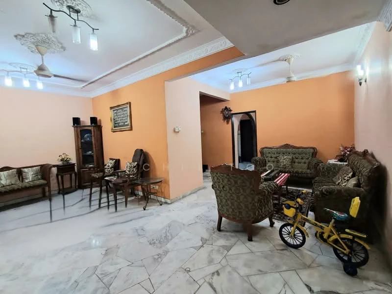 Living features: marble flooring, orange painted walls, tray ceiling, 5-blade ceiling fan with light, 2-seater fabric sofa in green, 3-seater fabric sofa in green, wooden coffee table, decorative wall art, armchair with floral upholstery, side table, bicycle, wall-mounted light fixtures; style: traditional.