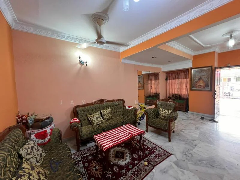 Living features: marble flooring, orange painted walls, crown moulding, 5-blade ceiling fan, sofa set with floral upholstery, coffee table, area rug with geometric pattern, wall-mounted lighting, curtains on windows; style: traditional.
