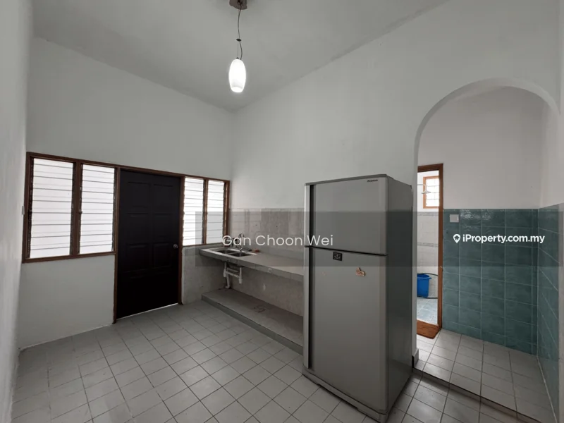 Kitchen features: white painted walls, grey tiled backsplash, white ceiling, single-bowl stainless-steel sink, chrome faucet, built-in countertop, fridge, floor tiles in white, window with horizontal slats, door with black finish, blue tiled wall section, open space layout.