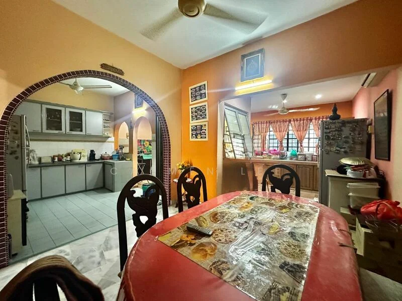 Dining features: round dining table with red tablecloth, wooden dining chairs, ceiling fan, wall-mounted artwork, arched doorway leading to kitchen, tile flooring, decorative wall, natural light from window; style: traditional. Kitchen features: L-shaped kitchen layout, stainless-steel sink, built-in cabinets, countertop with tile backsplash, kitchen appliances visible, window with curtains, tile flooring, recessed lighting; style: traditional.
