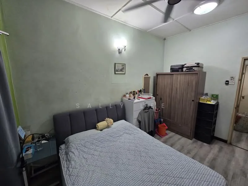 Bedroom features: grey upholstered bed, light green painted walls, wooden flooring, ceiling fan, wall-mounted light fixture, built-in wardrobe, freestanding dresser, nightstand, decorative artwork, window with curtain.
