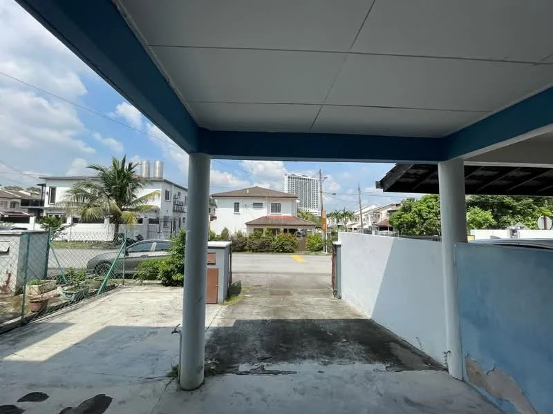 Exterior features: concrete flooring, blue painted ceiling, two concrete columns, fenced perimeter, paved driveway, surrounding greenery, city skyline in background, residential street view; style: modern.