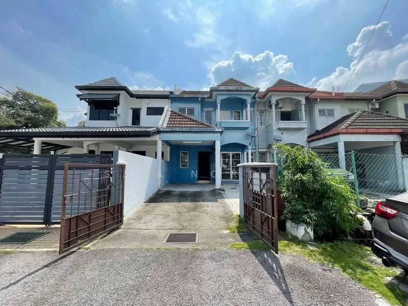 Exterior type: linked terrace house; features: white painted facade, blue accent wall, pitched tile roof, two-storey structure, manicured lawn, driveway with interlocking pavers, covered car porch, front garden with shrubs, security gate at entrance; style: modern.