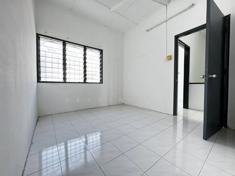 Room features: white painted walls, white tiled flooring, black framed windows, horizontal window grills, ceiling fan, single door, light fixture, no visible furniture; style: minimalist.