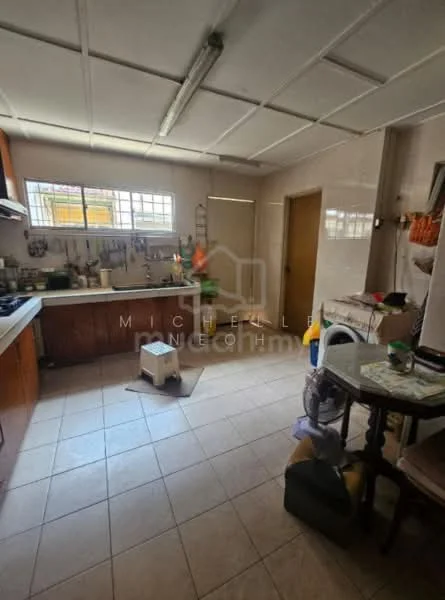 Kitchen features: wood cabinetry, ceramic tile flooring, white walls, double-bowl stainless-steel sink, chrome pull-down faucet, built-in gas stove, exhaust hood, window above sink, kitchen island, table with chairs, various kitchen utensils, open shelving, refrigerator, wall-mounted storage, light fixture.