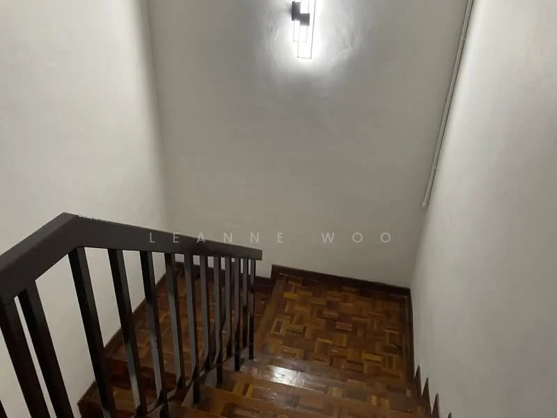 Room features: wooden staircase, parquet wood flooring, white painted walls, wall-mounted light fixture.