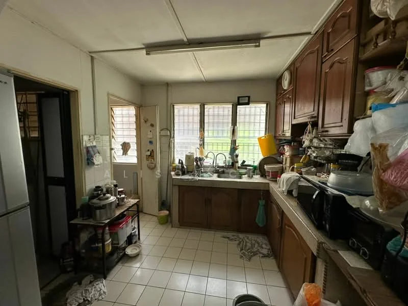Kitchen features: wood cabinetry, double-bowl stainless-steel sink, chrome pull-down faucet, countertop with tile surface, built-in microwave, freestanding refrigerator, kitchen island, ceramic tile flooring, window with grid pattern, wall clock, various kitchen appliances, messy countertop with utensils.
