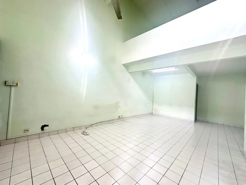 Room features: light green painted walls, white tiled flooring, high ceiling, fluorescent ceiling lights, no visible furniture, empty space.