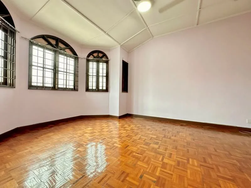 Room features: parquet wood flooring, light purple painted walls, sloped ceiling, 5-blade ceiling fan, multiple windows with black frames, corner windows, natural light, no visible furniture.