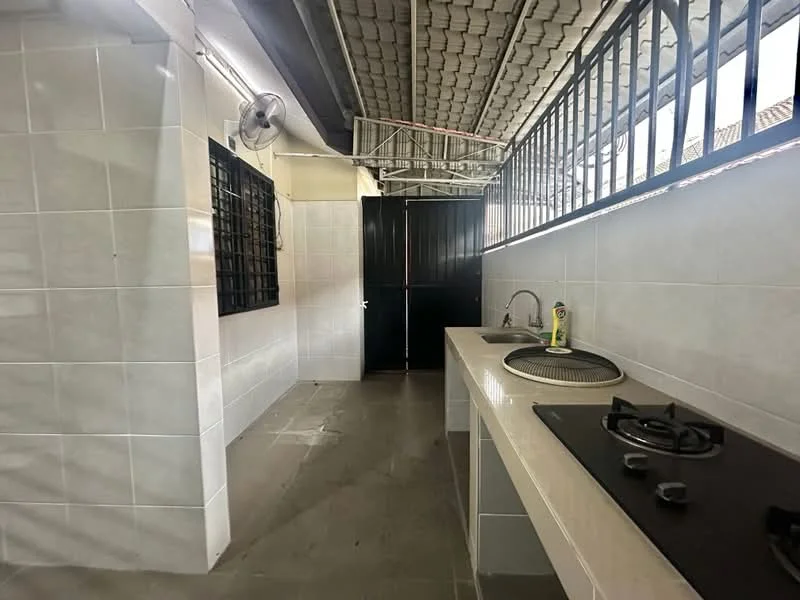 Kitchen features: white tiled walls, grey tiled flooring, single-bowl stainless-steel sink, chrome pull-down faucet, 4-burner gas hob, exhaust fan, window with metal bars, open layout, countertop with storage underneath.
