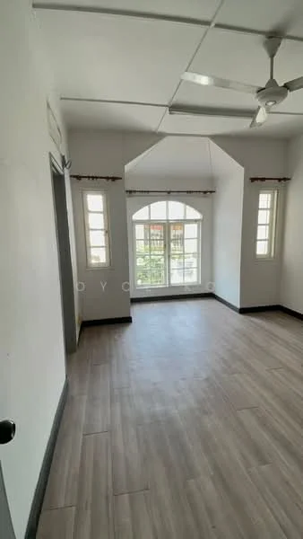 Room features: white painted walls, light wood laminate flooring, 5-blade ceiling fan, multiple windows, window treatments, corner window with arch, door with handle, baseboards; style: modern; view: garden.